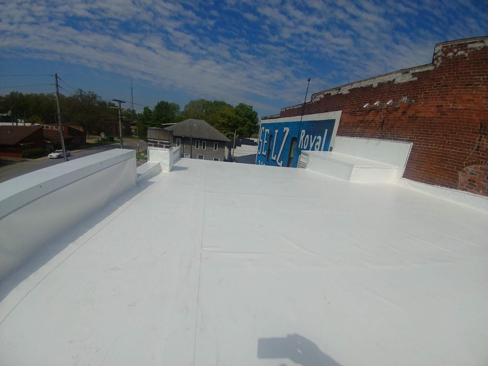 A white roof with a blue sign on it.