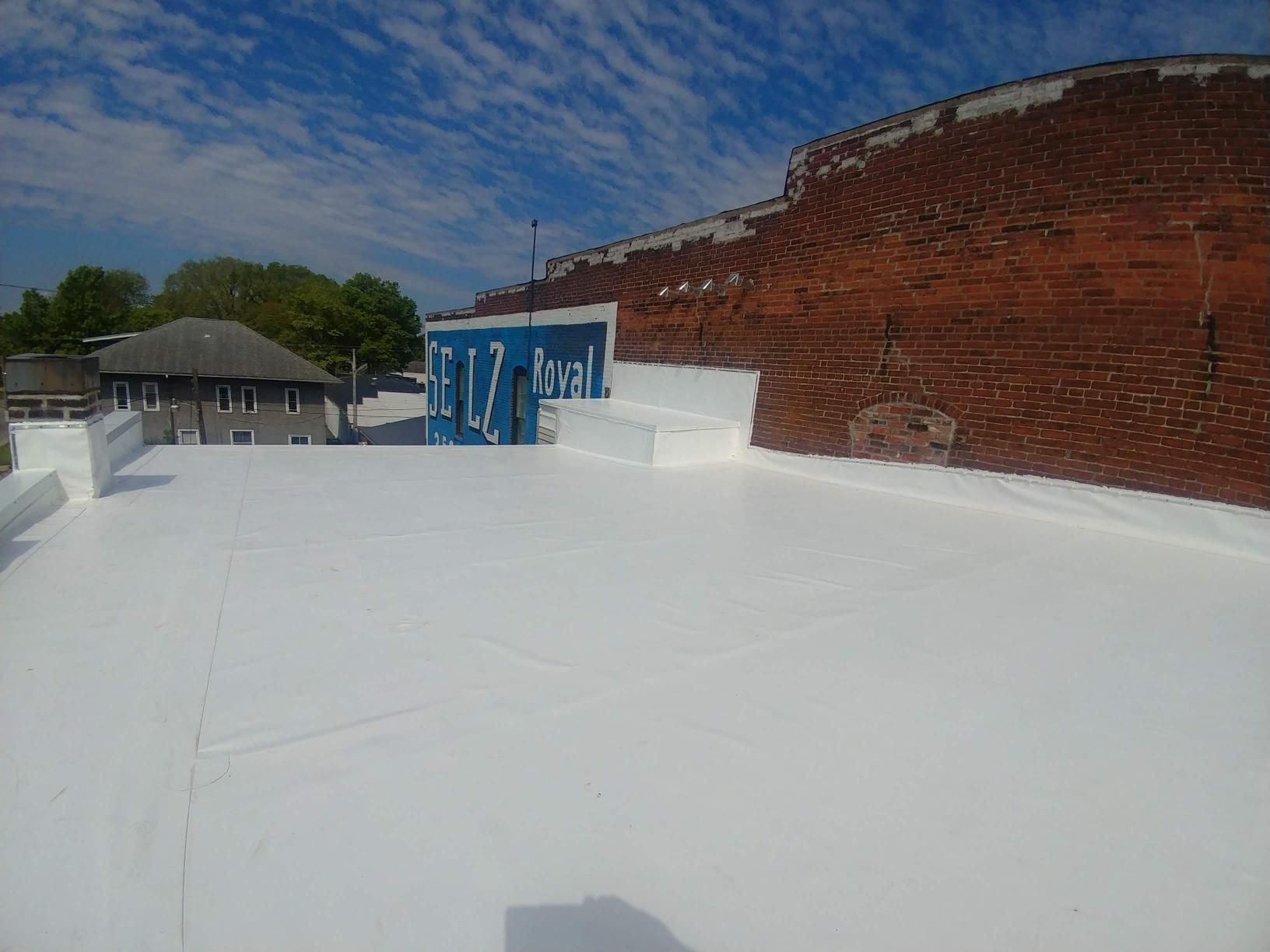 A white roof with a blue sign on top of it.