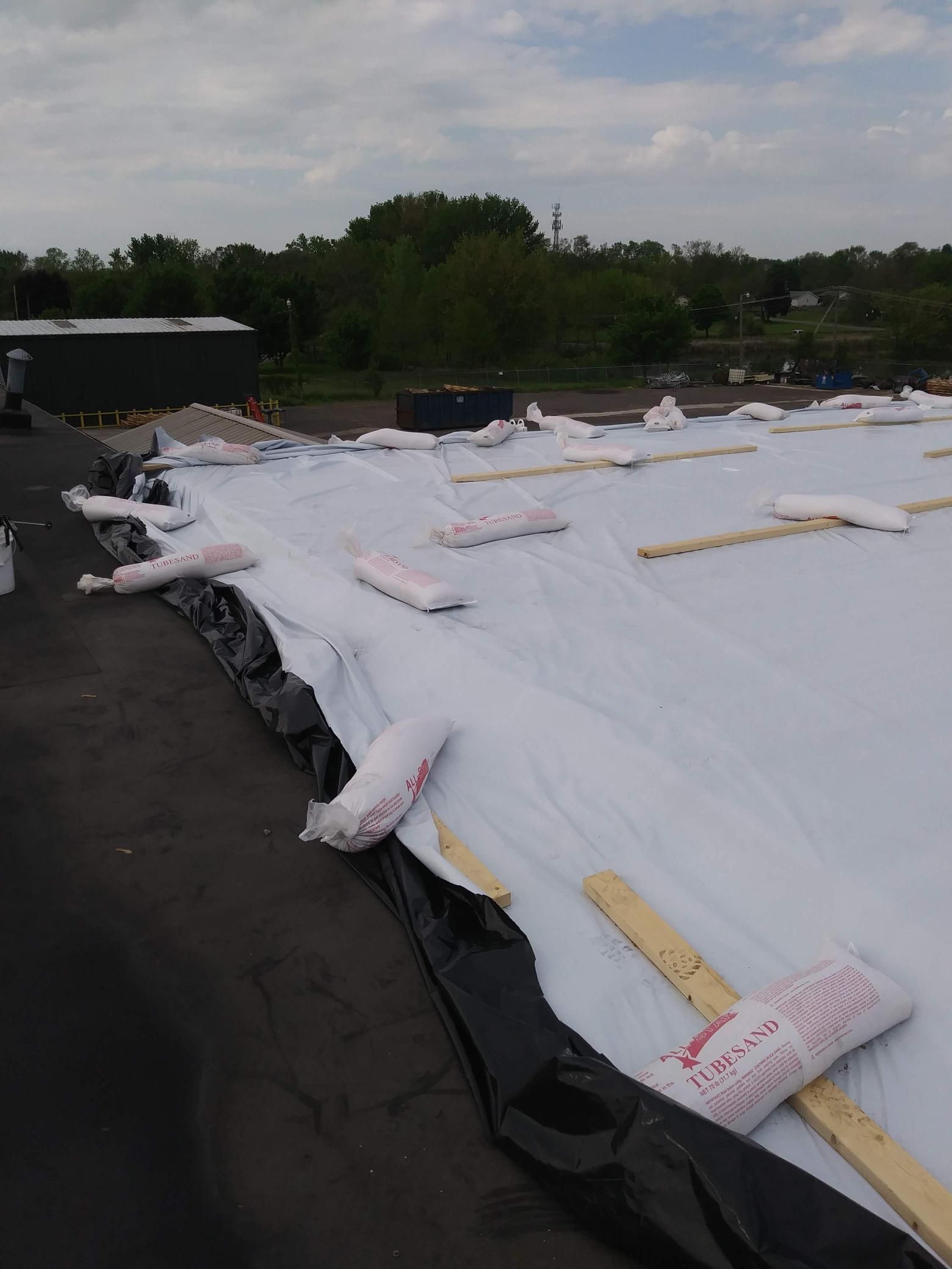 A roof with a lot of rolls of insulation on it