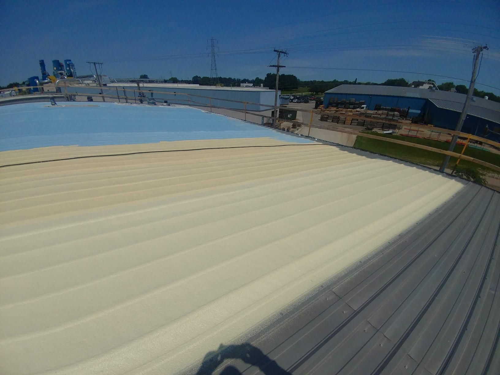 A roof with a lot of lines on it and a blue sky in the background.