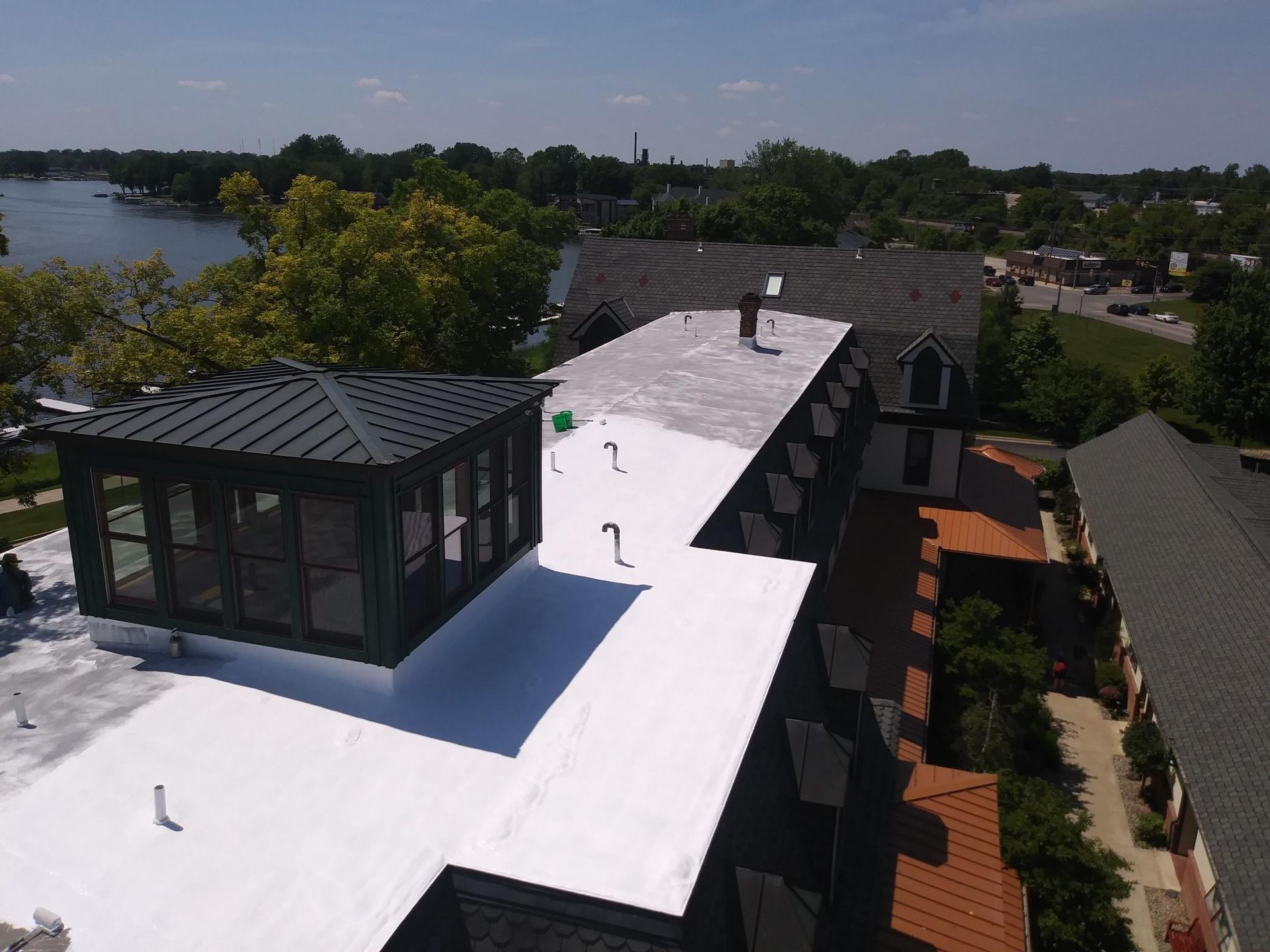 An aerial view of a building with a white roof.