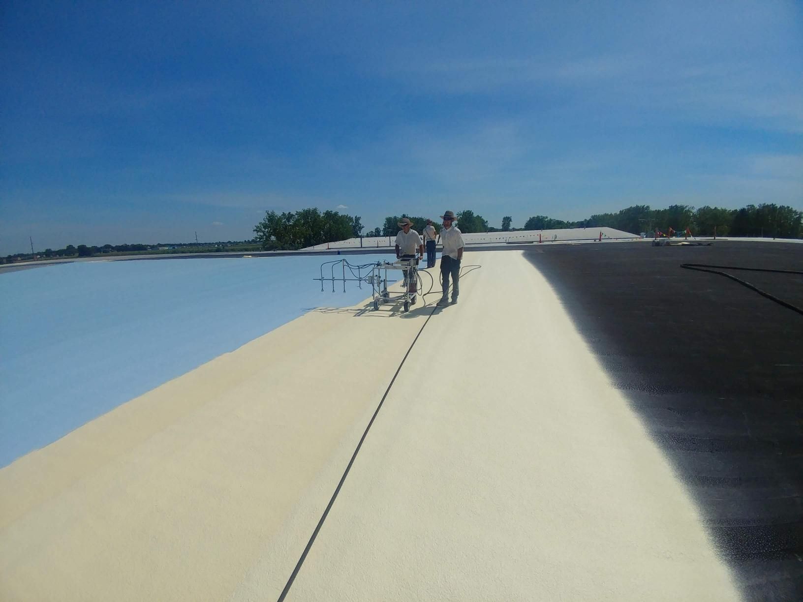 A group of people are standing on top of a roof.
