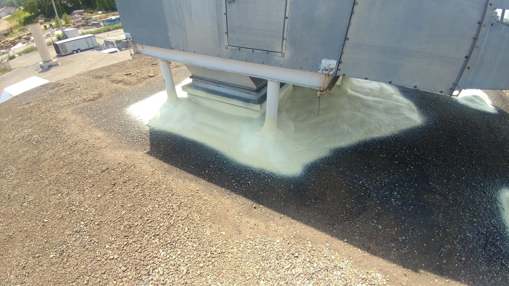 A large piece of metal is sitting on top of a pile of gravel.