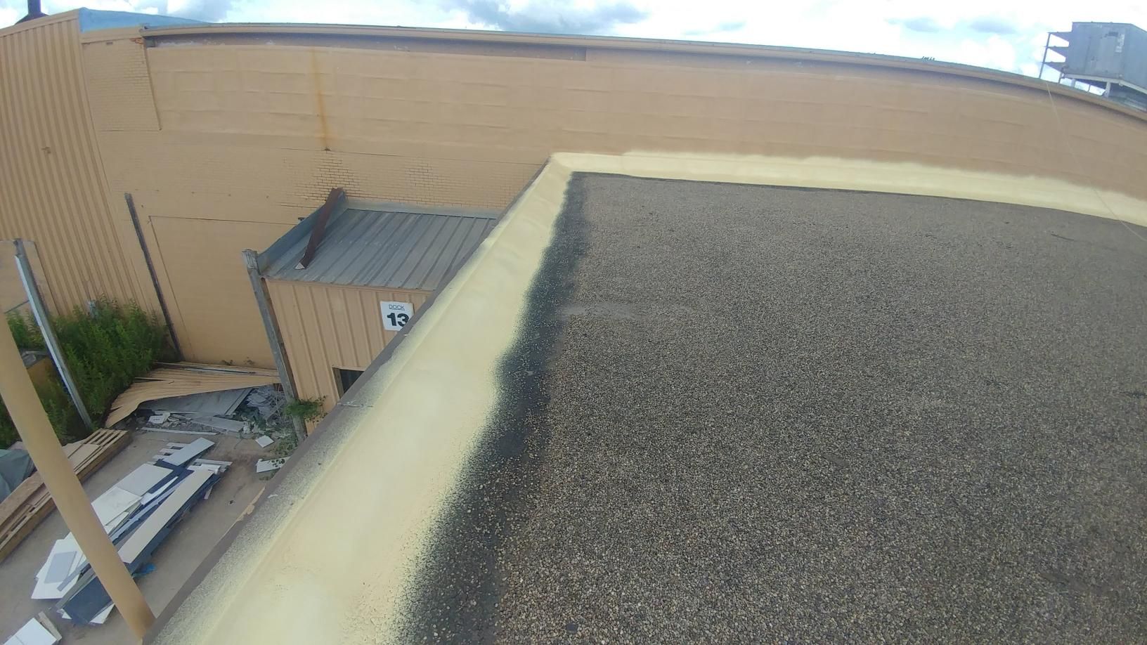 A large pile of gravel is sitting on top of a roof.