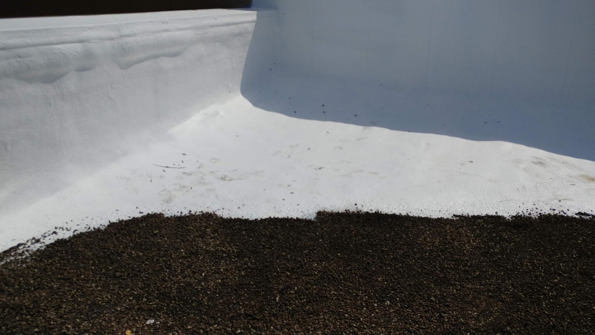 A pile of dirt is sitting on top of a white surface.