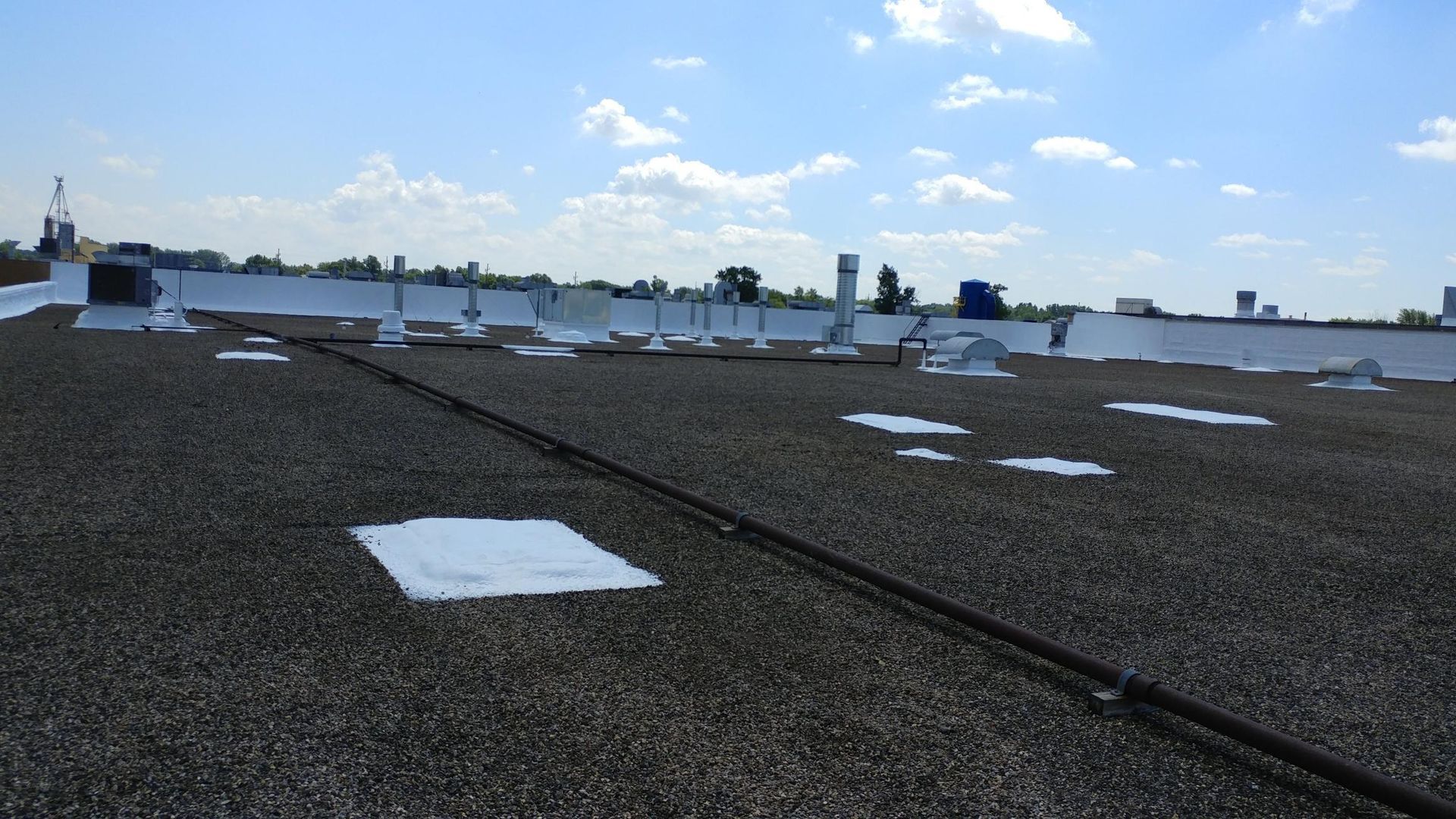 The roof of a building with a blue sky in the background
