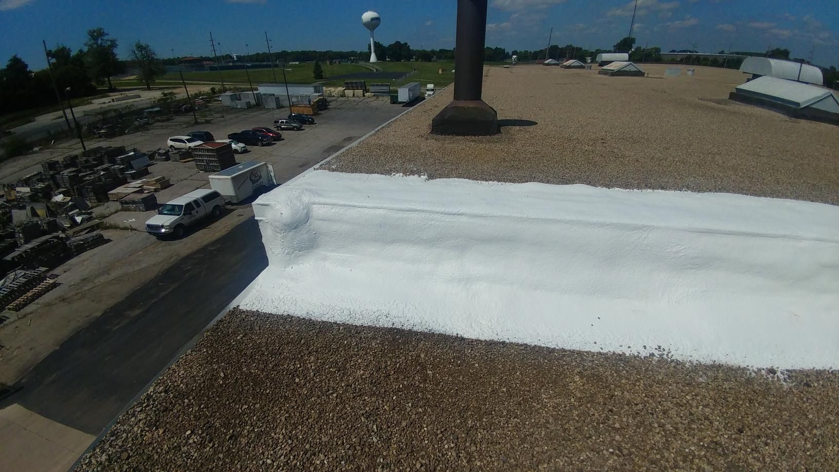 A white van is parked on the roof of a building.