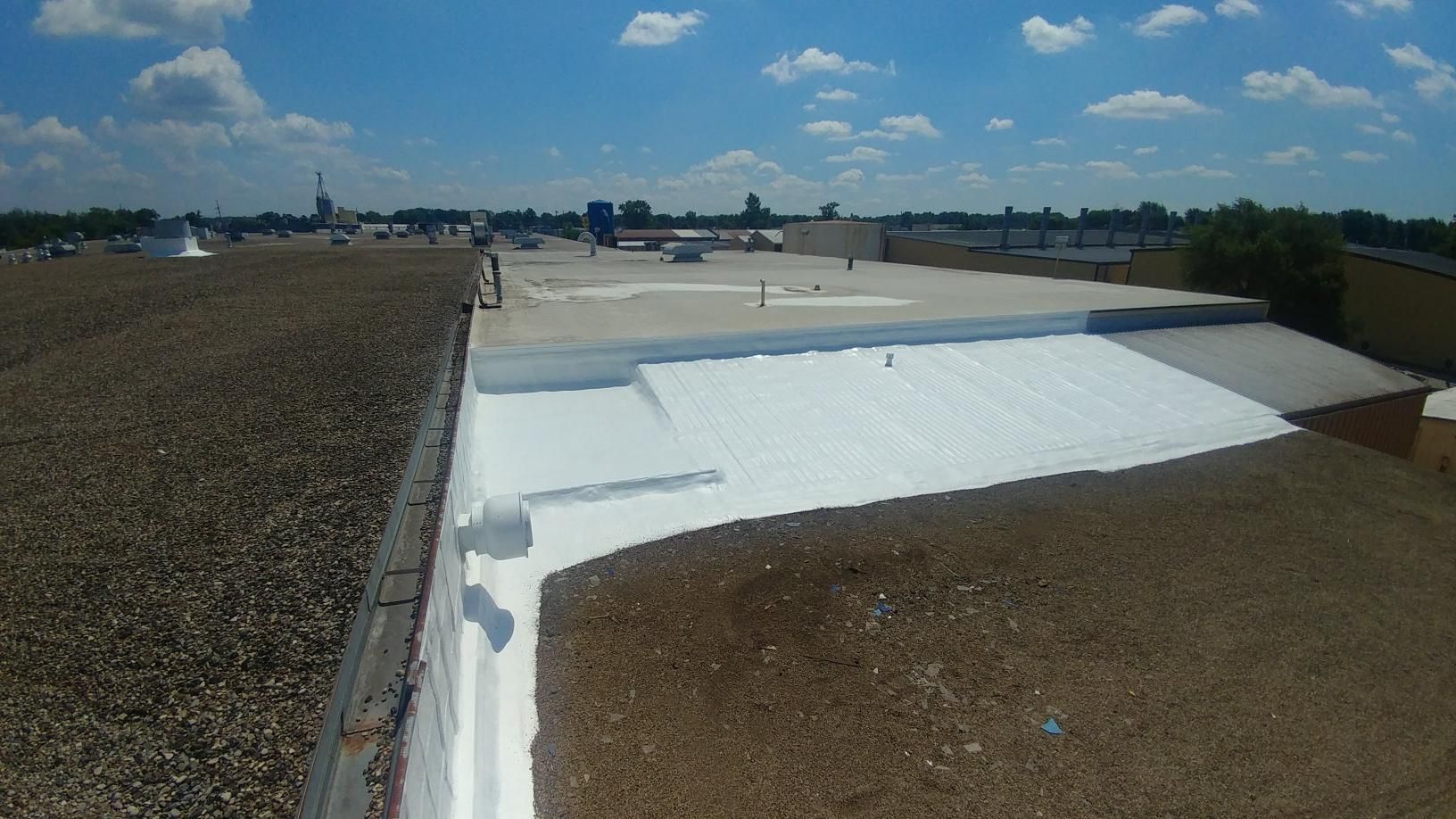 The roof of a building with a white coating on it