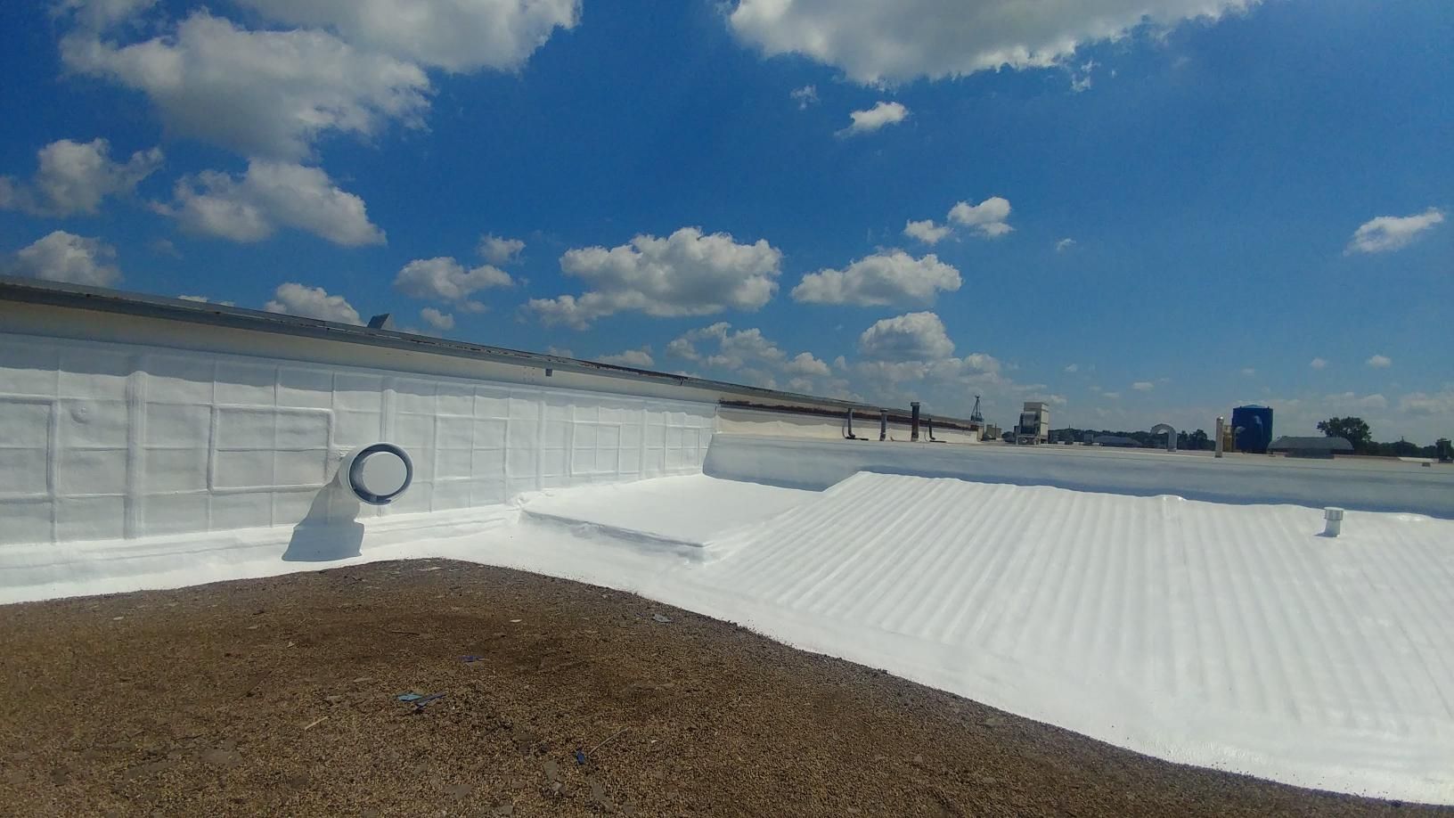 A large white roof with a blue sky in the background.