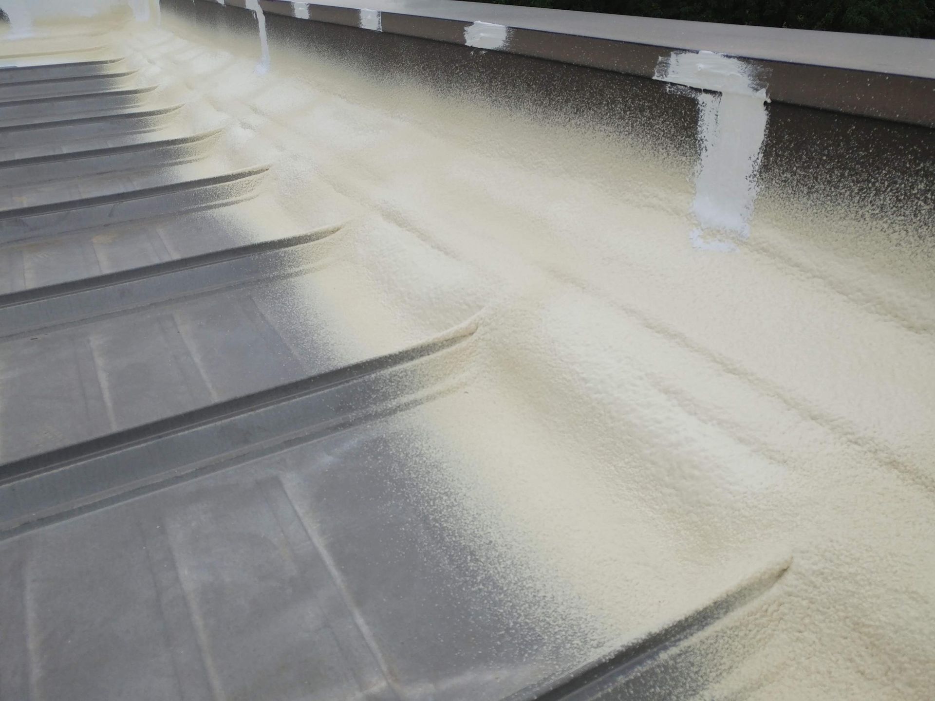 A close up of a roof with white paint on it.