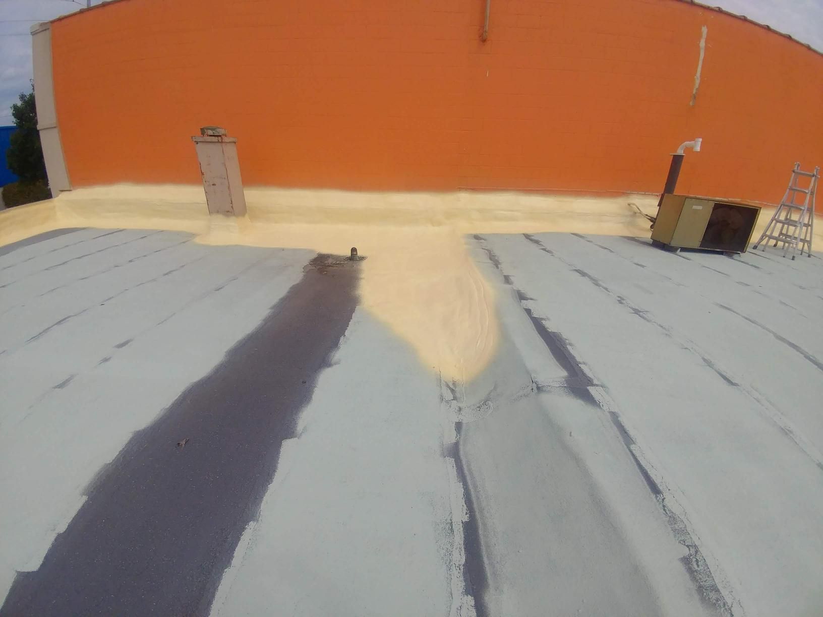 A roof with a chimney and a ladder on it