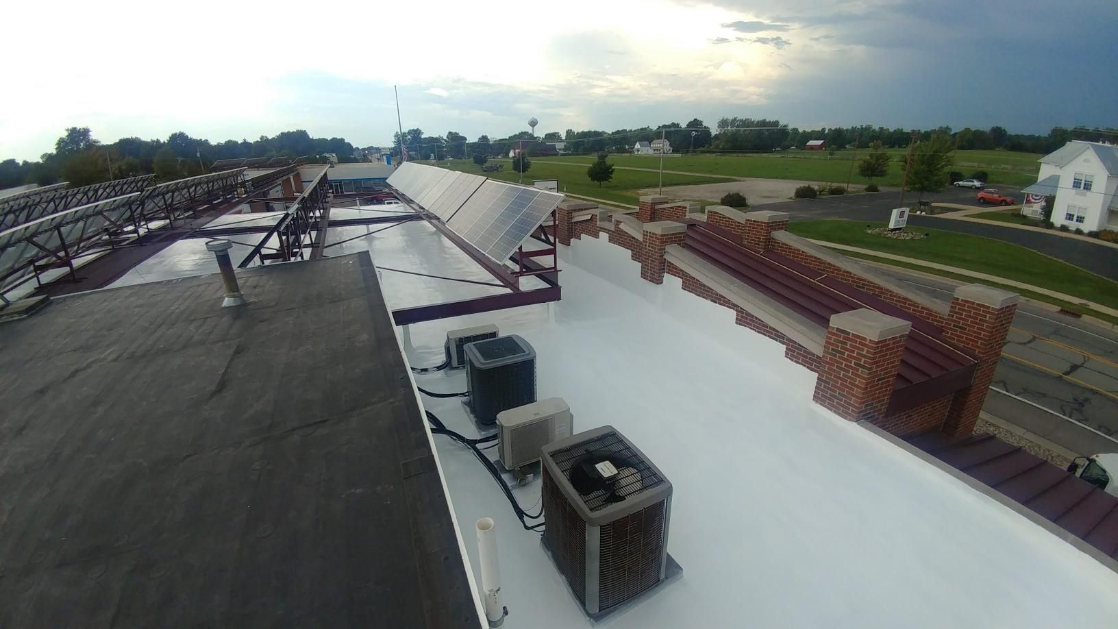 An aerial view of a roof with a few fans on it.