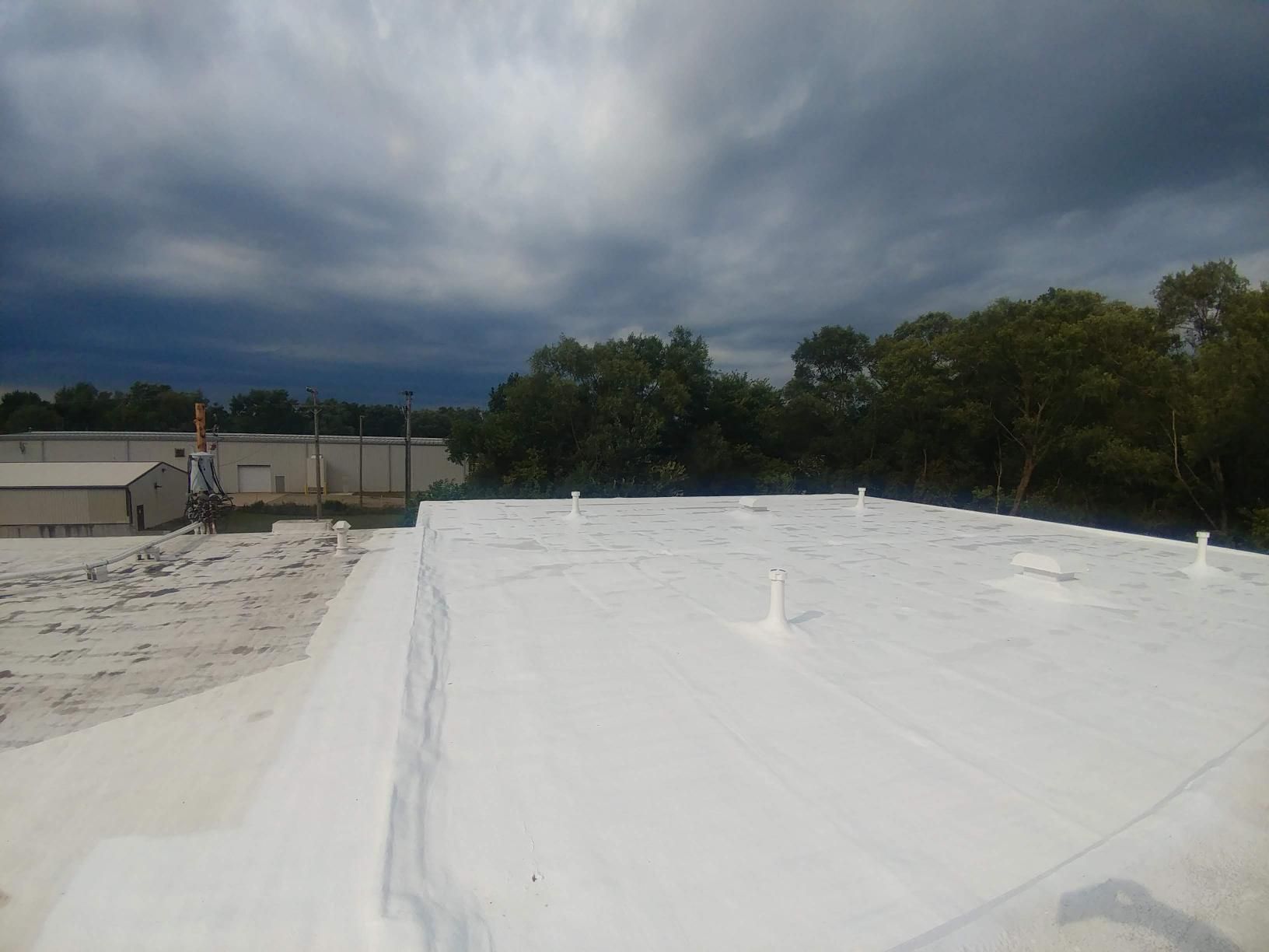 A white roof with a cloudy sky in the background.