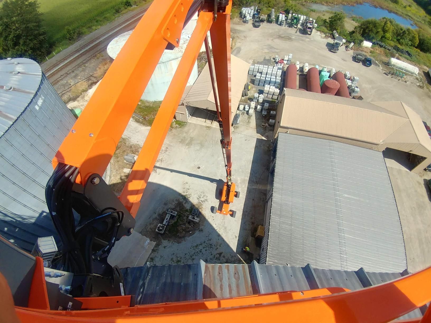An aerial view of a construction site with an orange crane