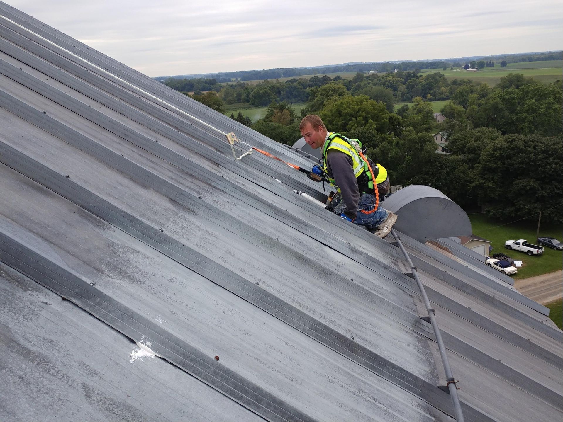 A man is working on the roof of a building.