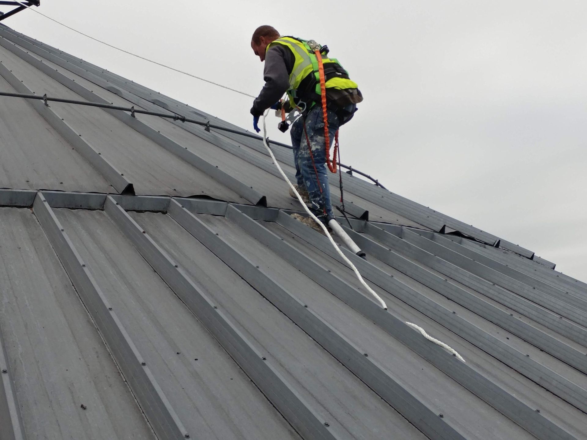 A man is working on the roof of a building