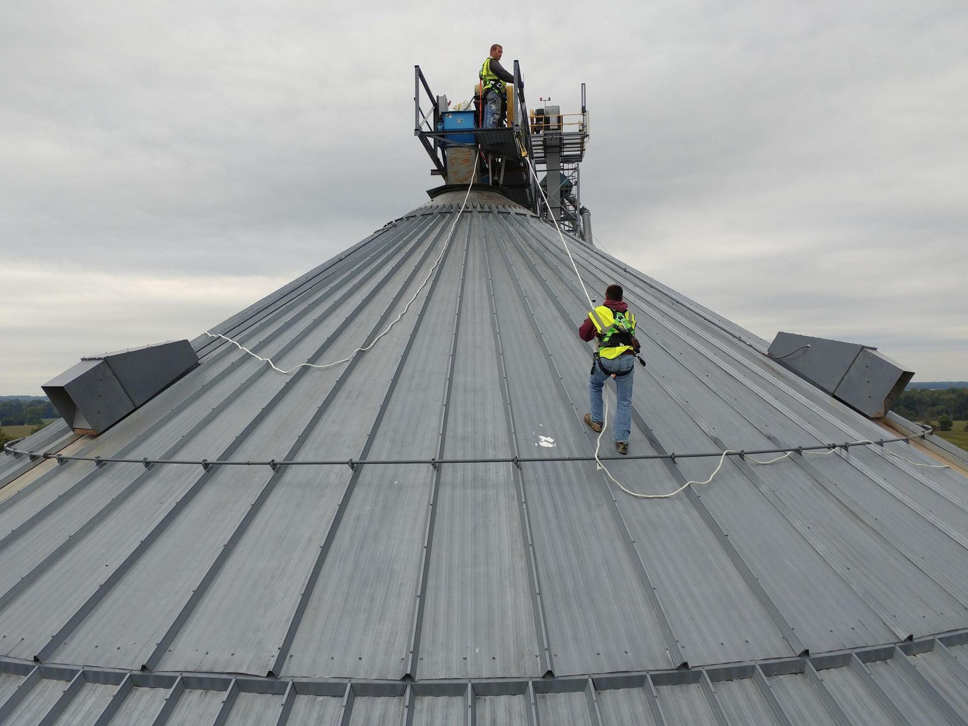 A man is standing on the roof of a building