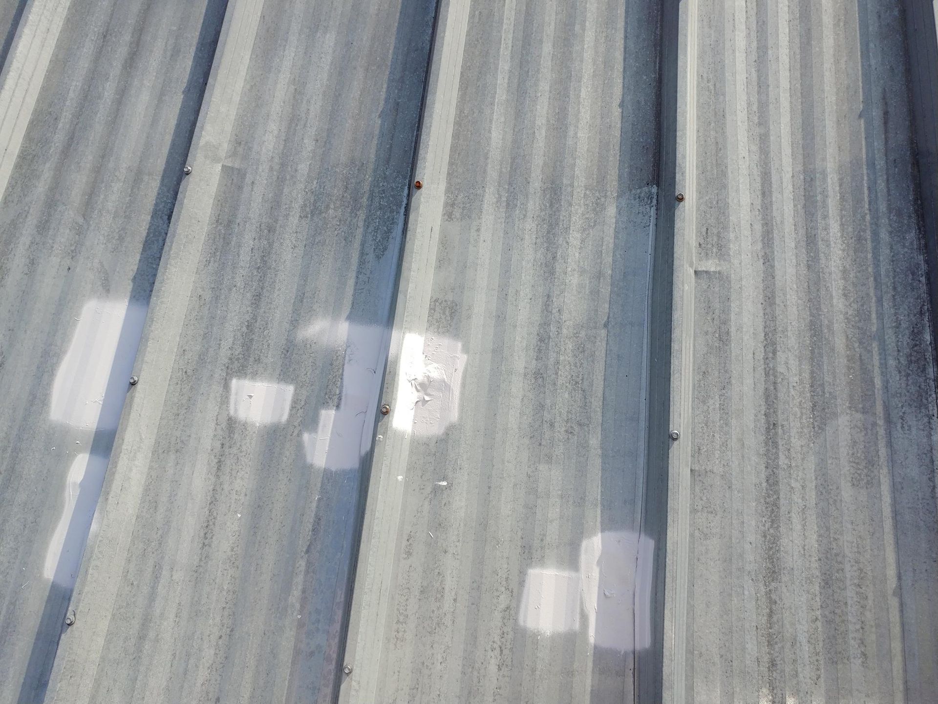 A close up of a metal roof with a lot of holes in it.