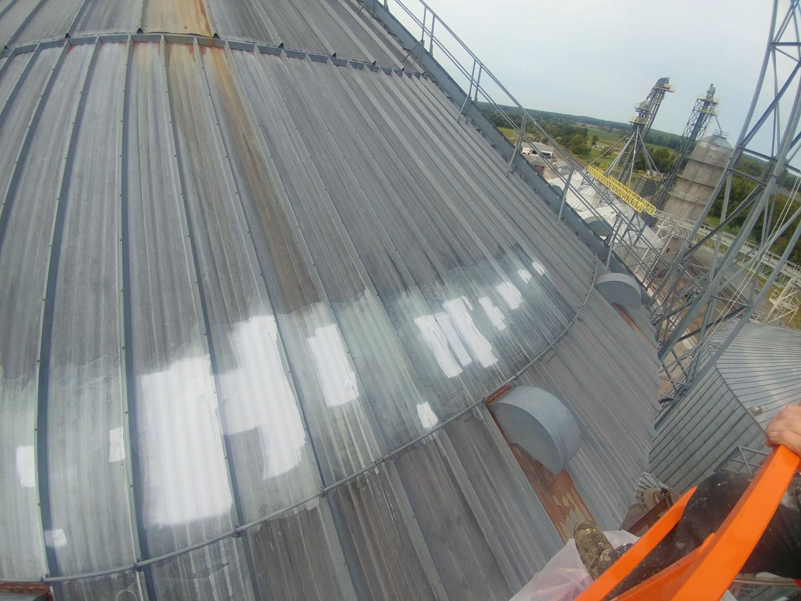 A very large building with a roof that is covered in plastic