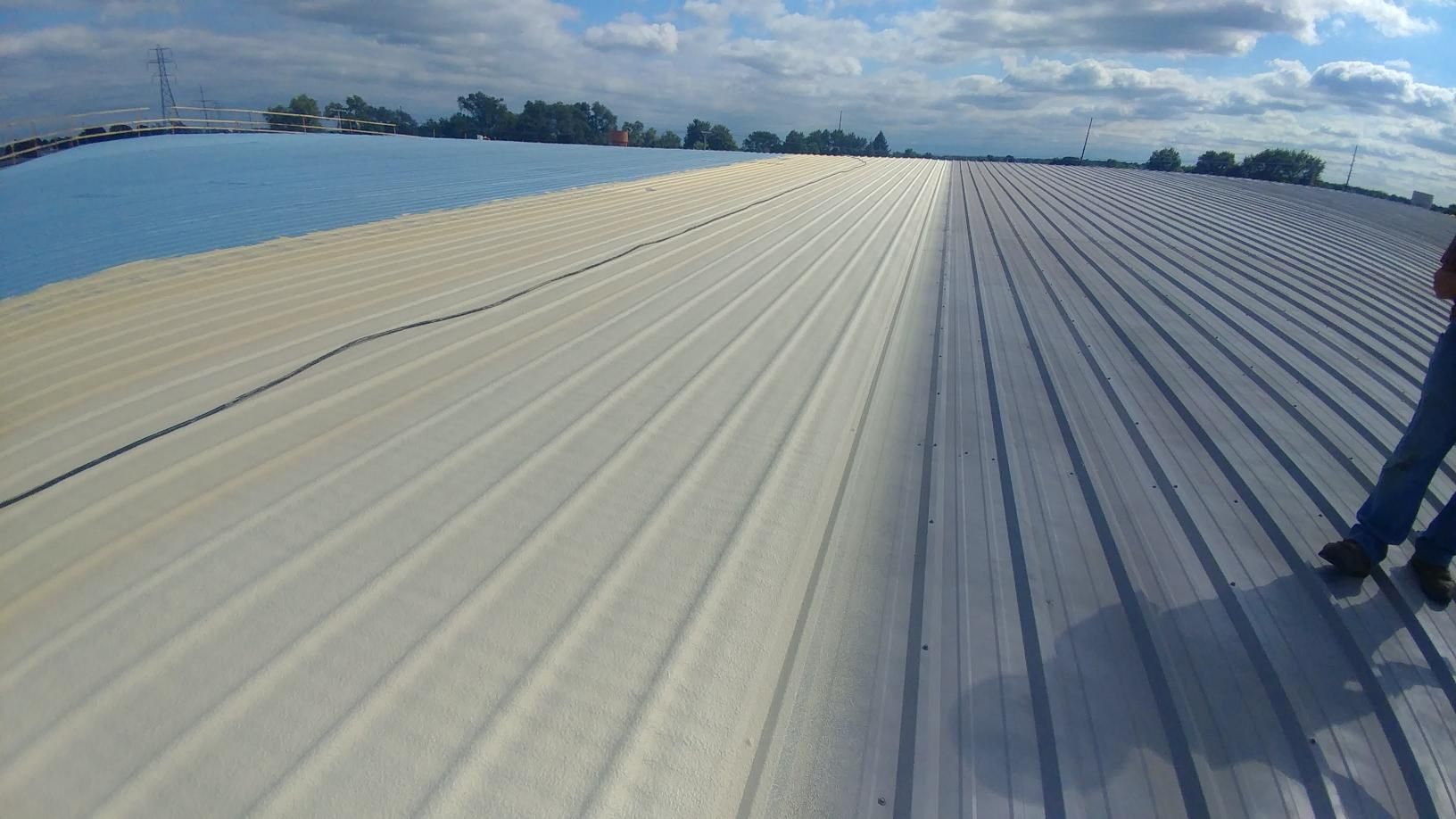 A man is standing on the roof of a building.