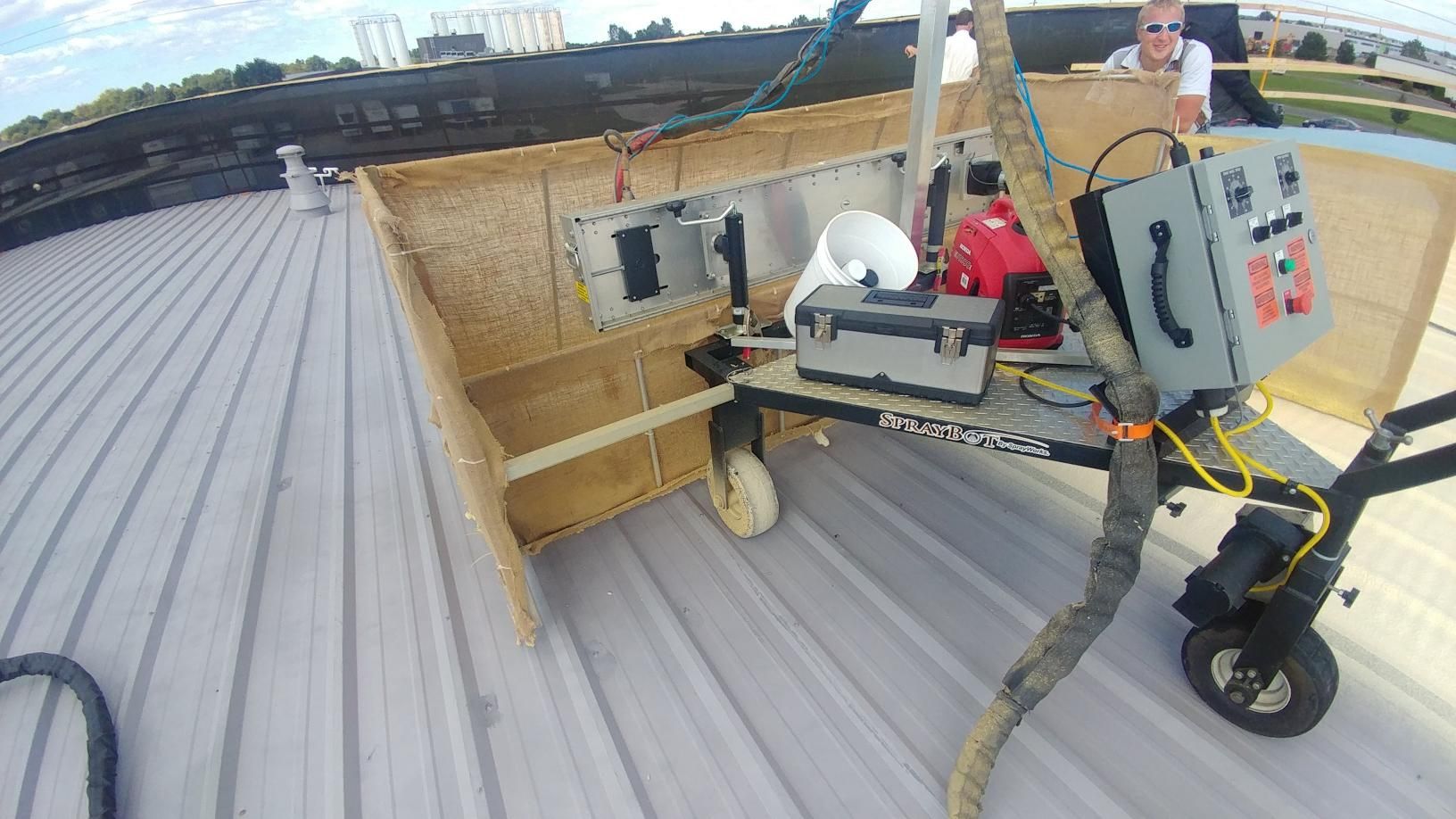 A man is sitting at a table with a cutting machine on it.