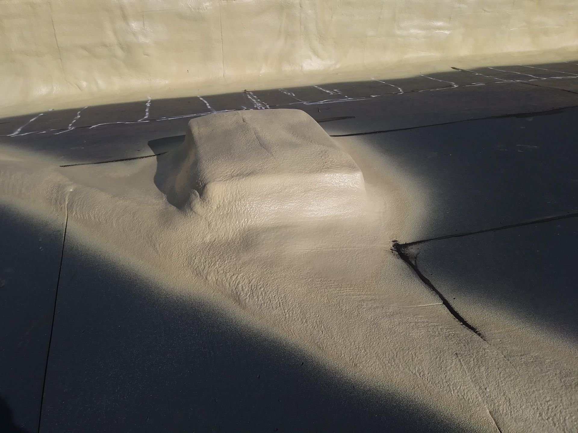A shadow of a person is cast on a concrete surface
