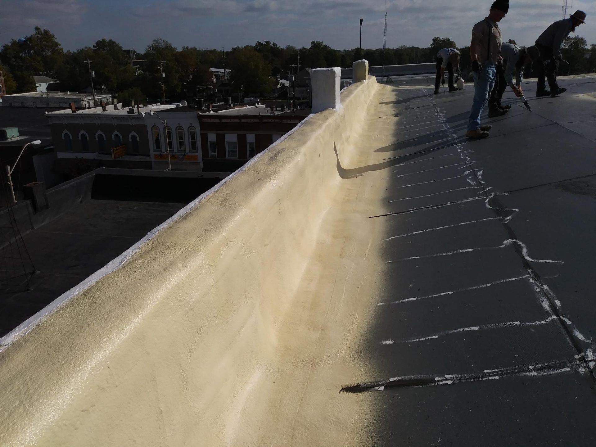 A group of people are working on the roof of a building