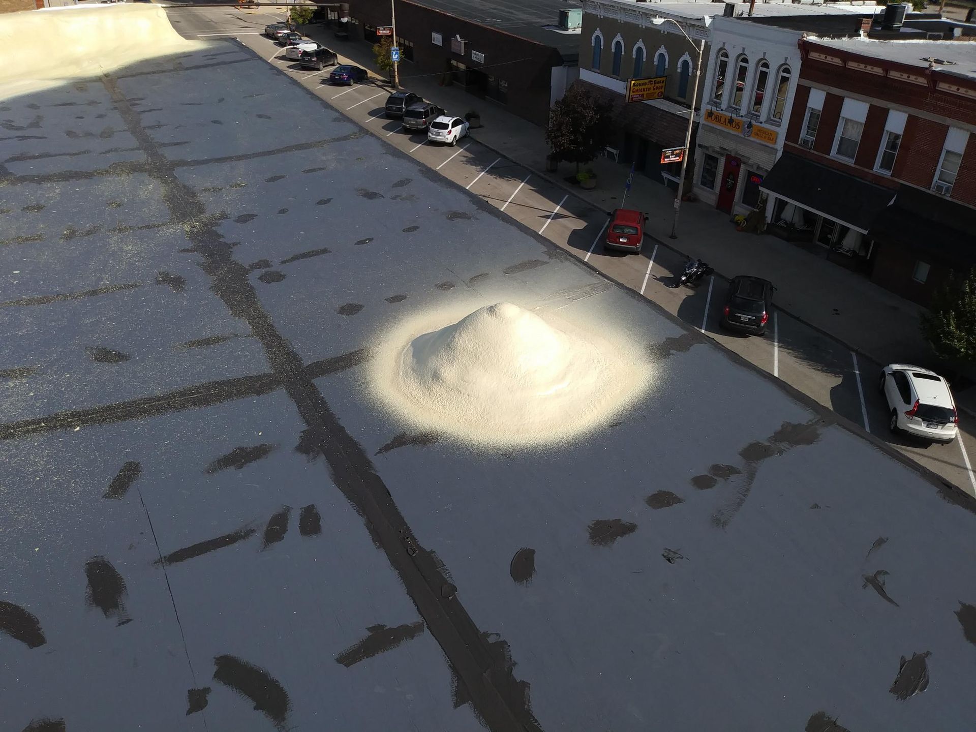 An aerial view of a city street with a light shining on the ground