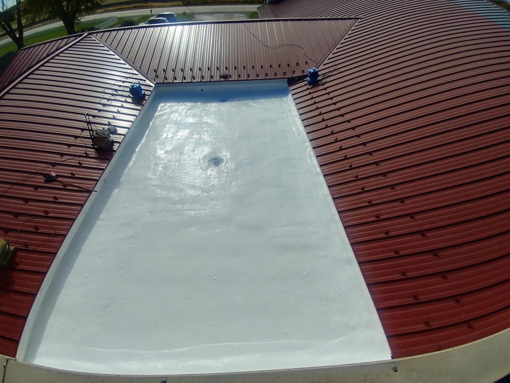 A red tiled roof with a white roof