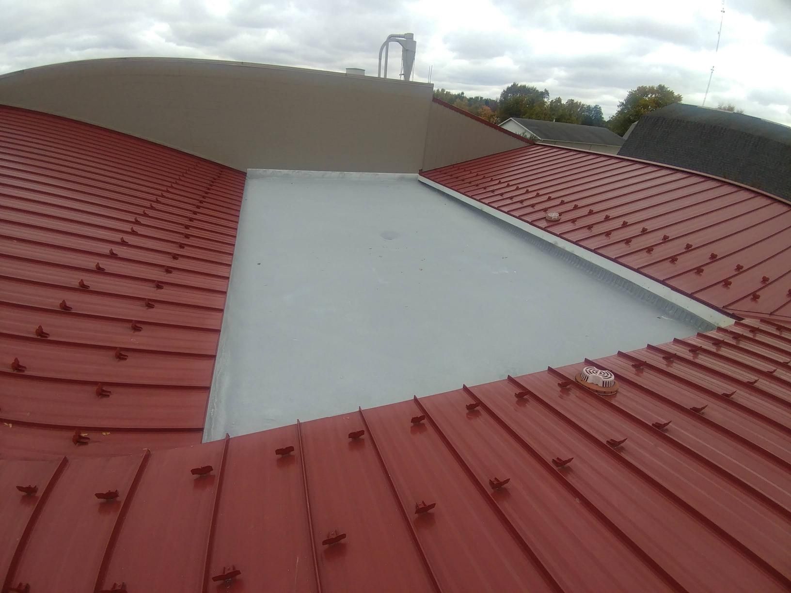 A red roof with a white skylight in the middle