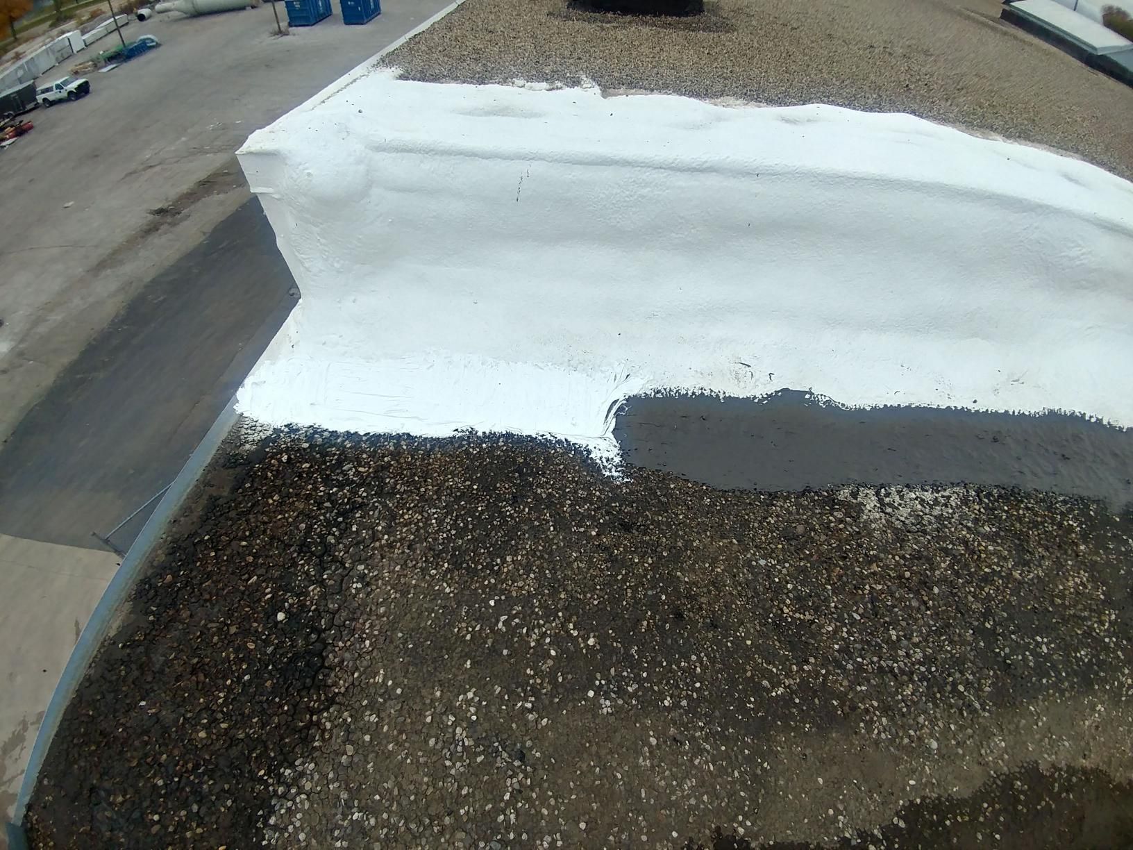 The roof of a building is being painted white