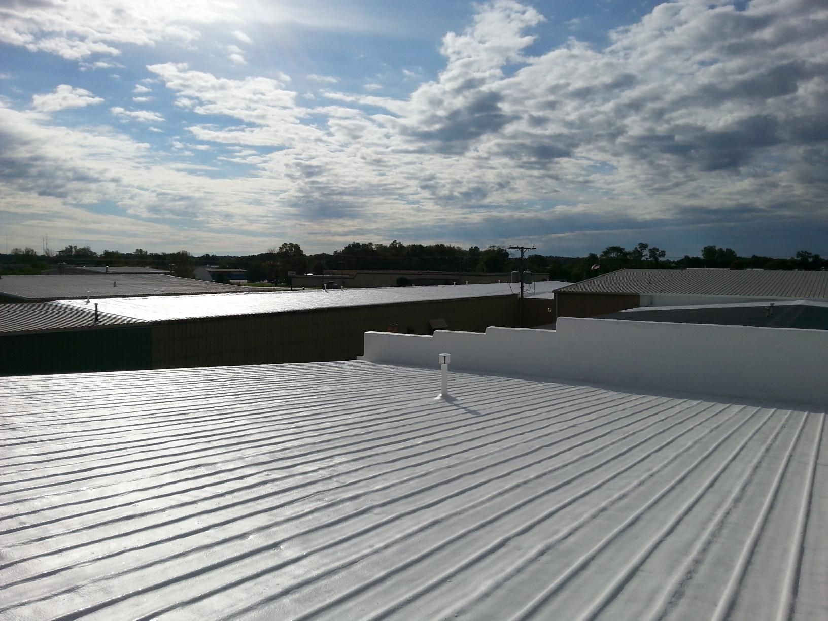 A white roof with a blue sky in the background.