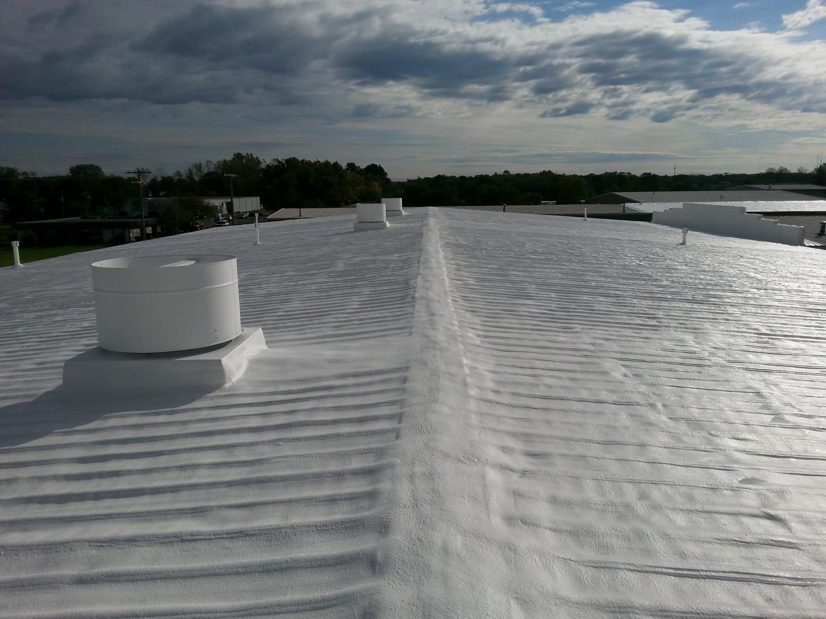 A white roof with a fan on top of it