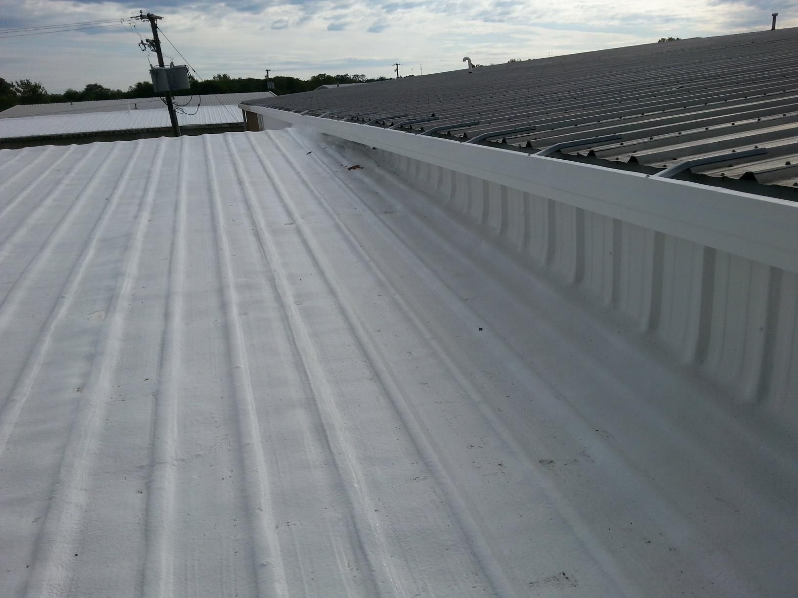 A white roof with a gutter on the side of it.