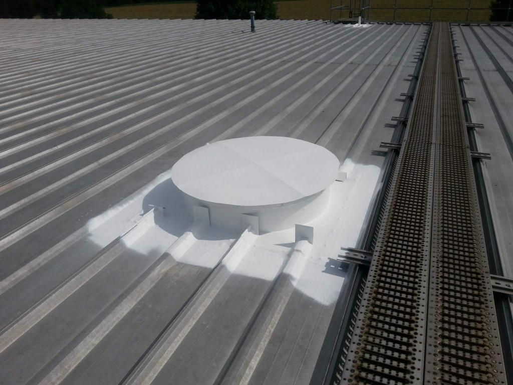 A metal roof with a round hole in the middle of it