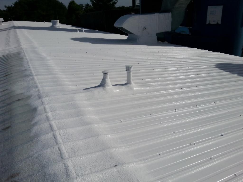 A white roof with two vents on it