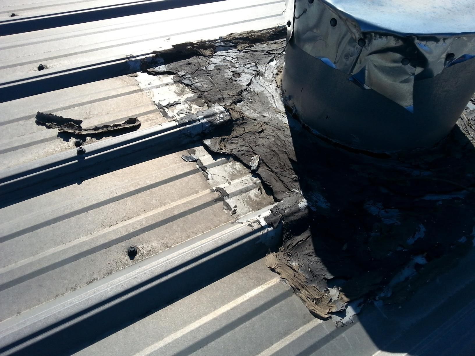 A metal roof with a chimney on top of it