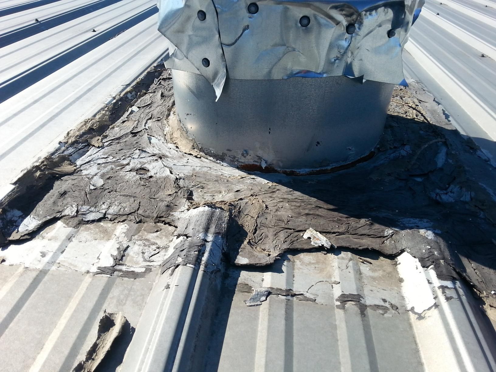 A metal roof with a hole in the middle of it