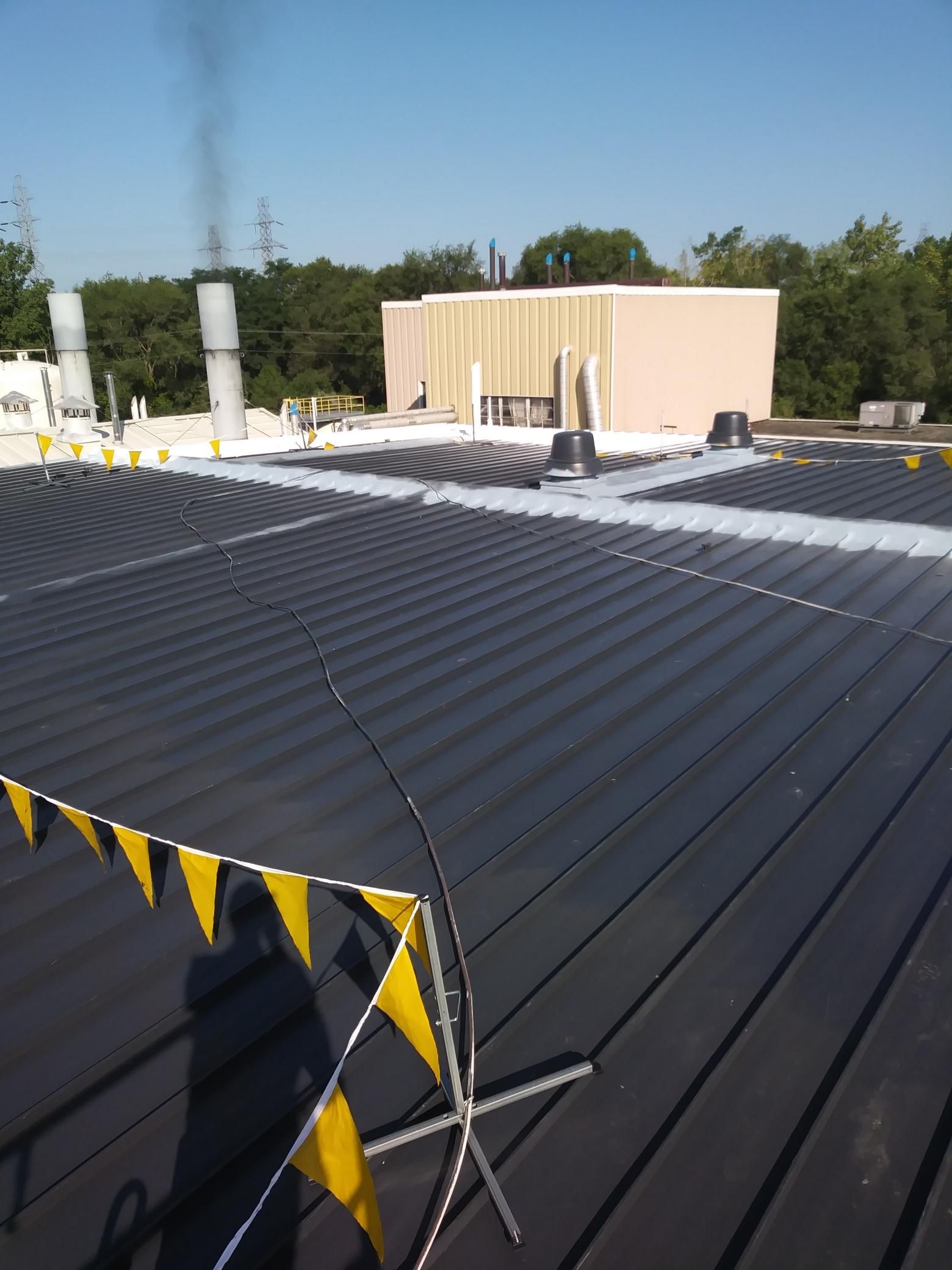 A black roof with yellow and black flags on it