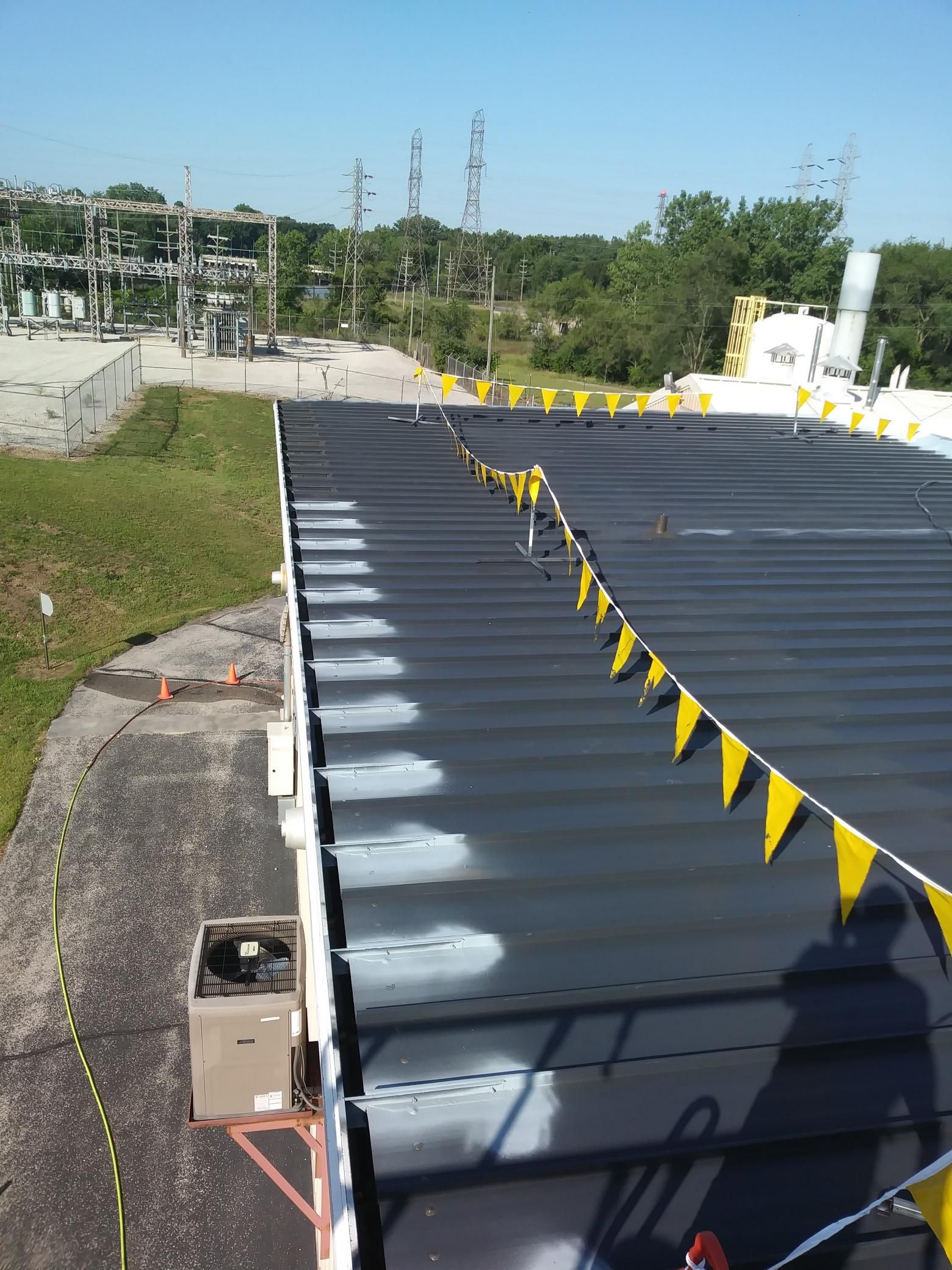 A black roof with yellow flags hanging from it