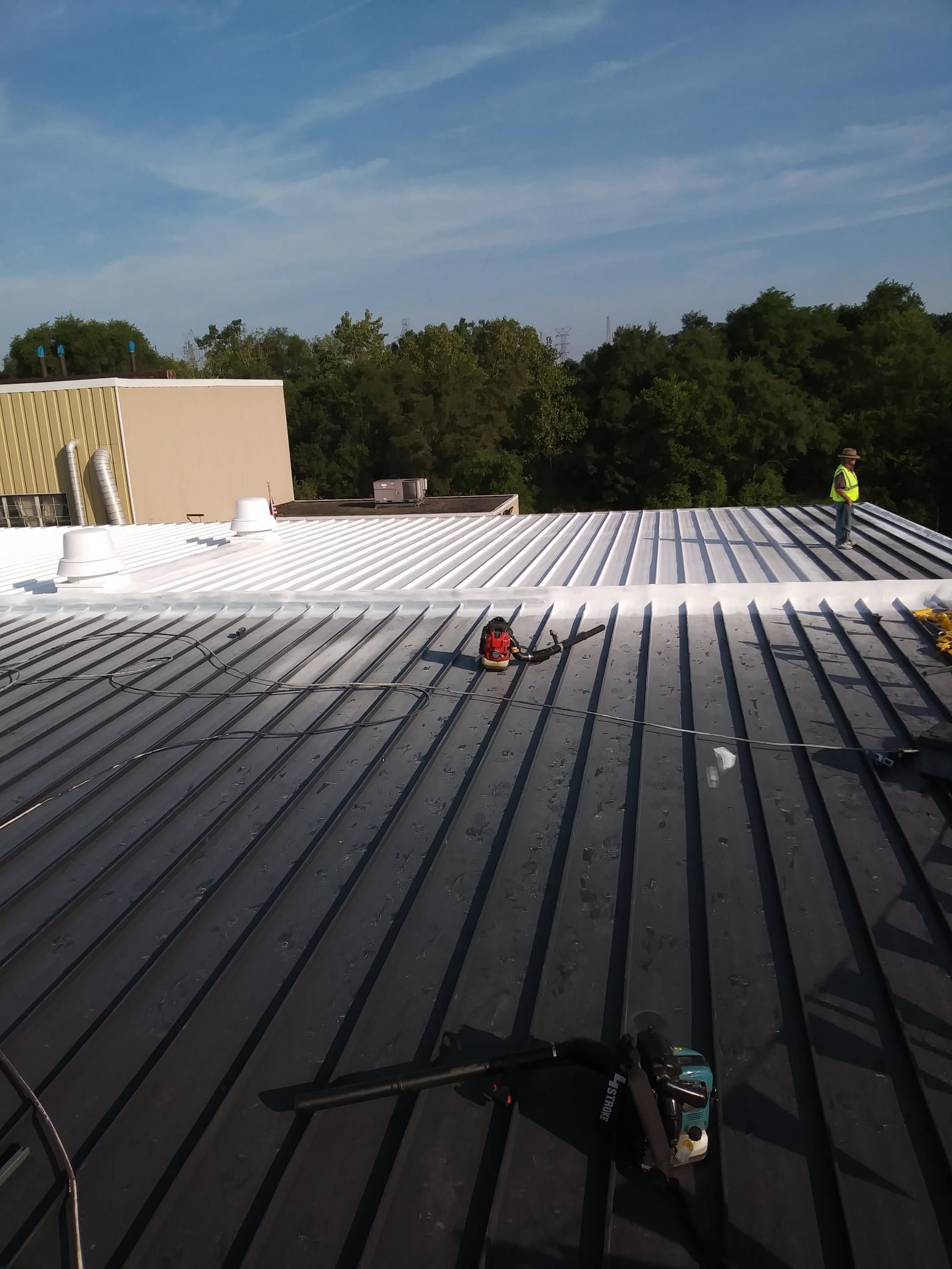 A man is working on the roof of a building