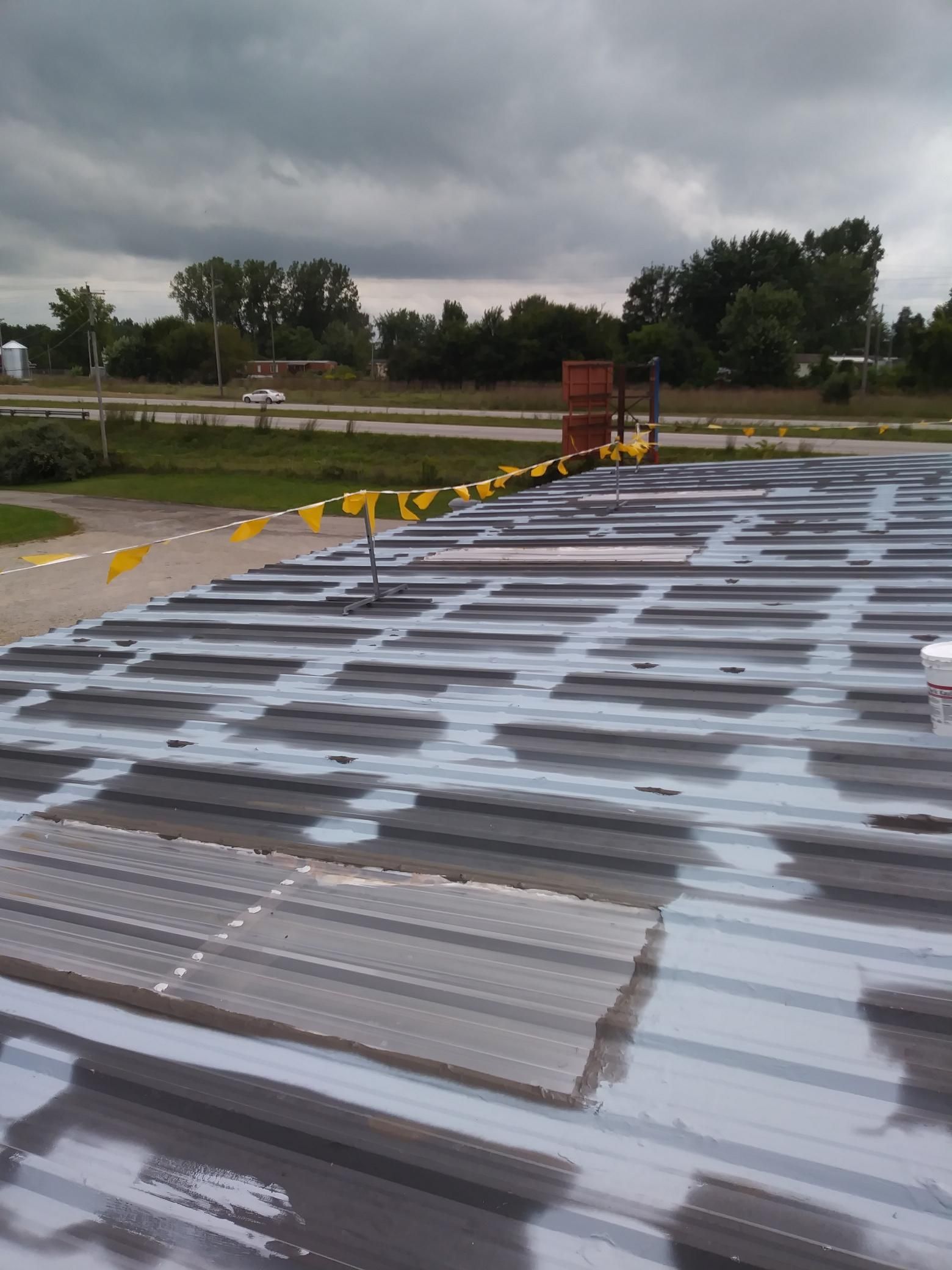 A roof with a lot of tiles on it and a cloudy sky in the background