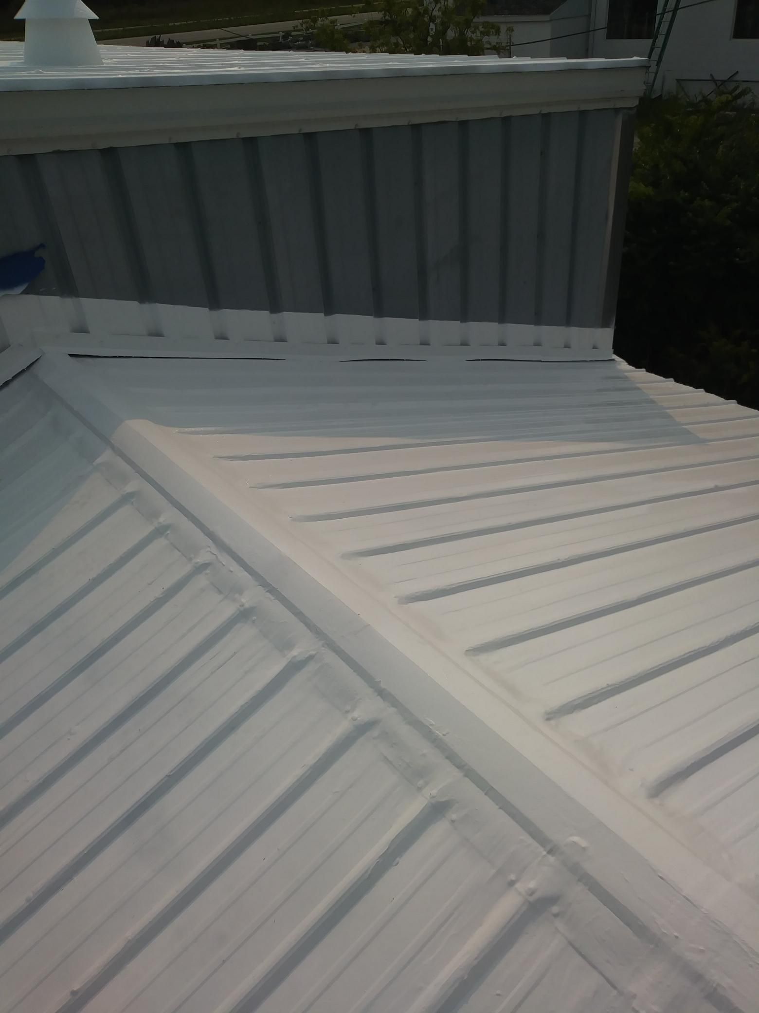 A white roof with a chimney on top of it