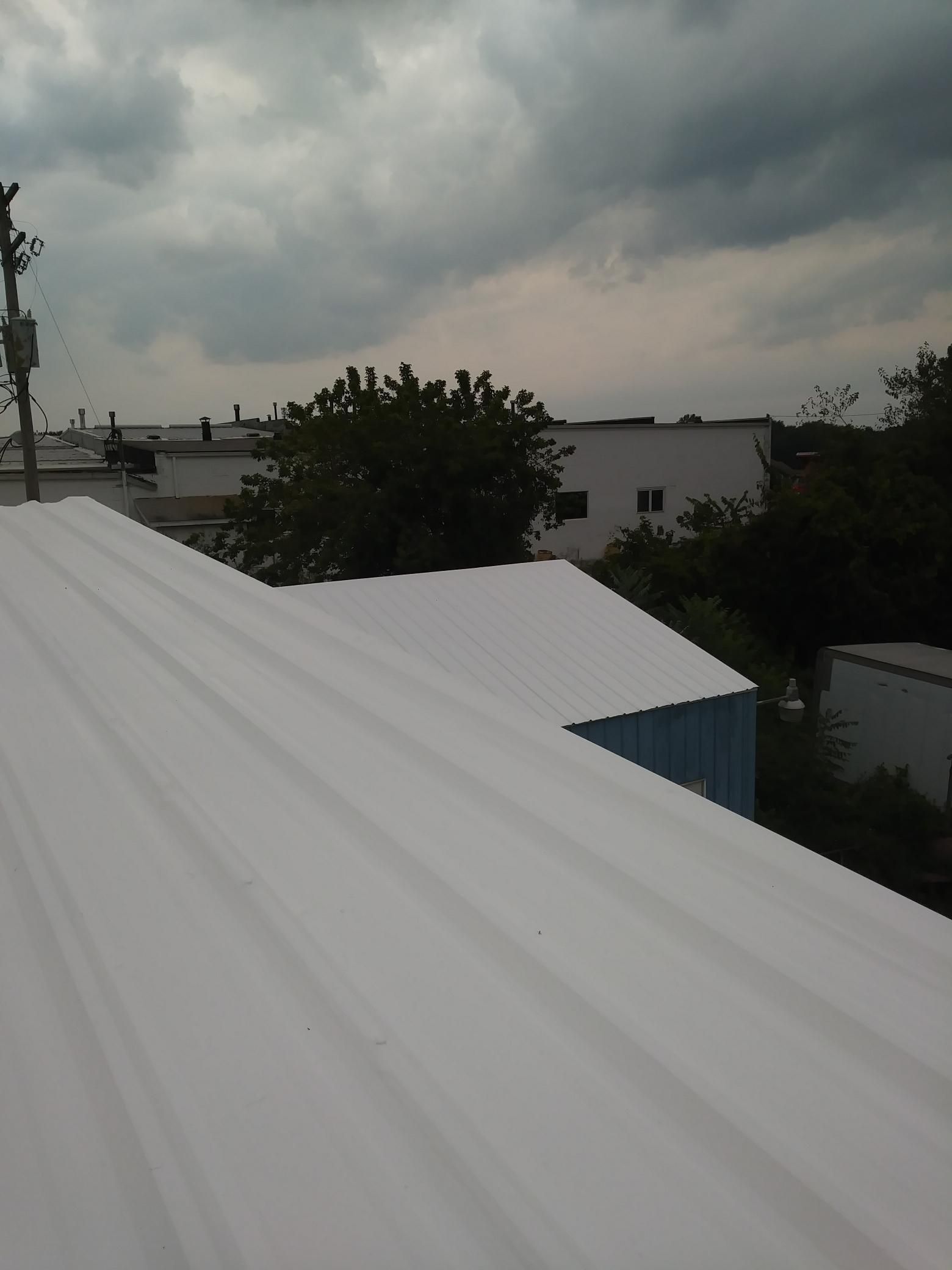 A white roof with a cloudy sky in the background