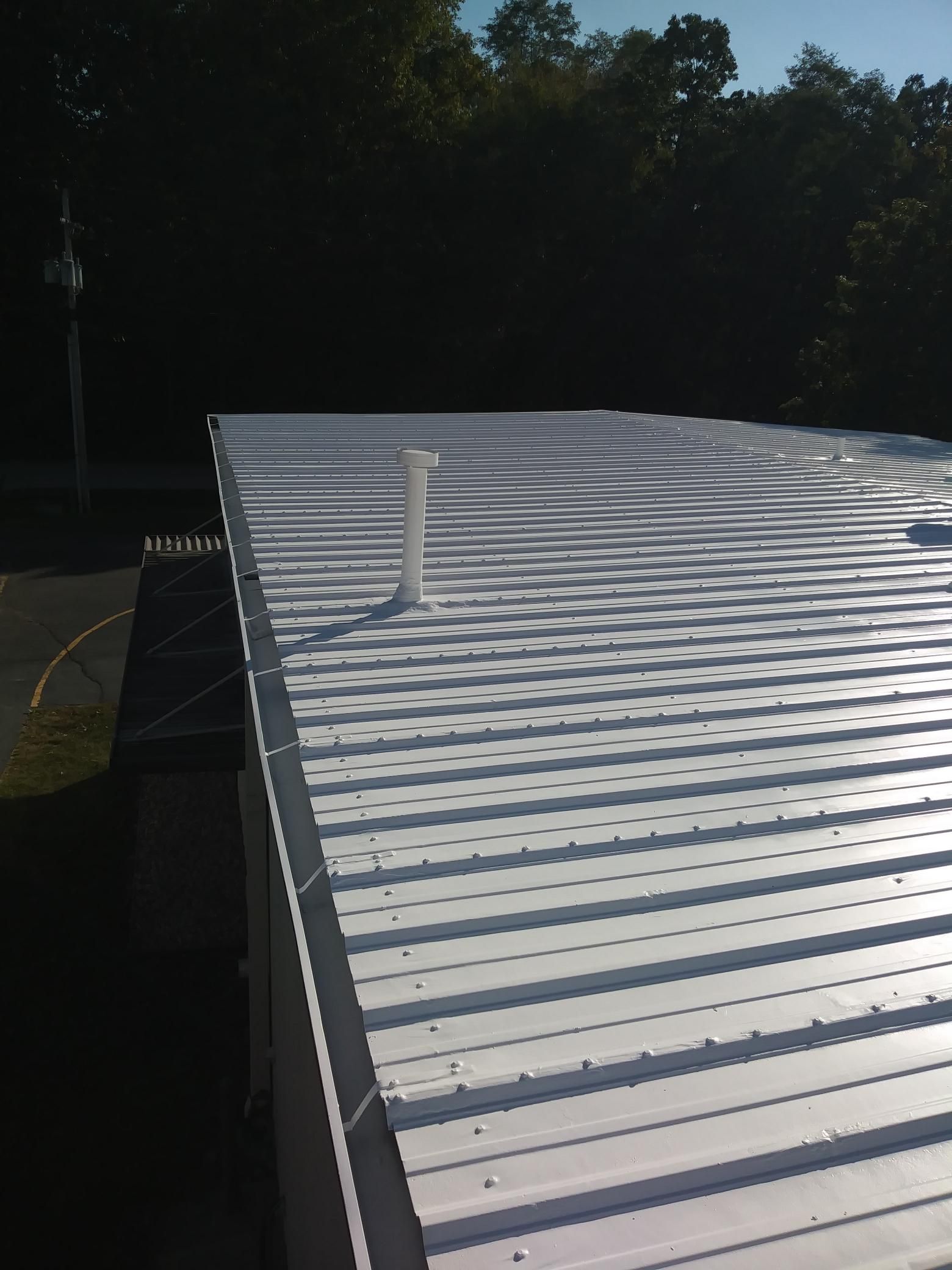 A white roof with a chimney on top of it