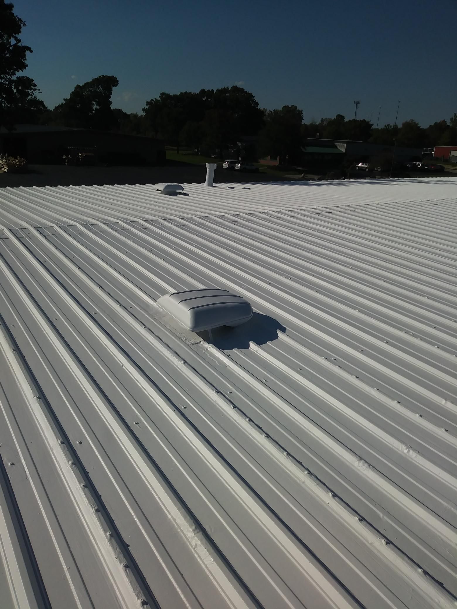 A white roof with a vent on top of it