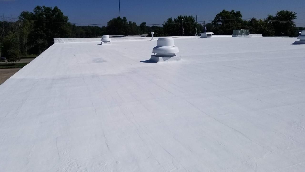 A white roof with a fan on top of it.