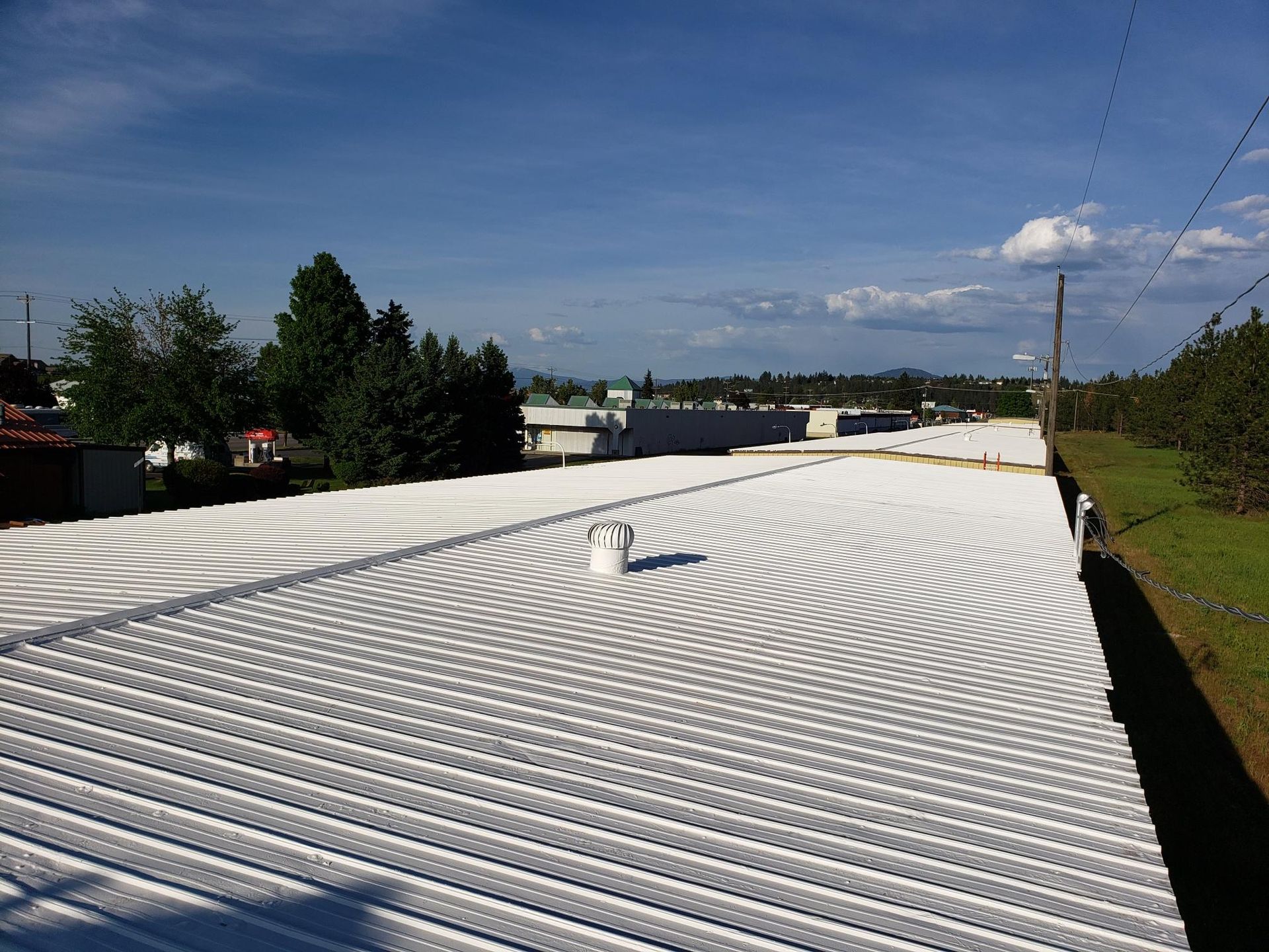 A large white roof with a blue sky in the background.