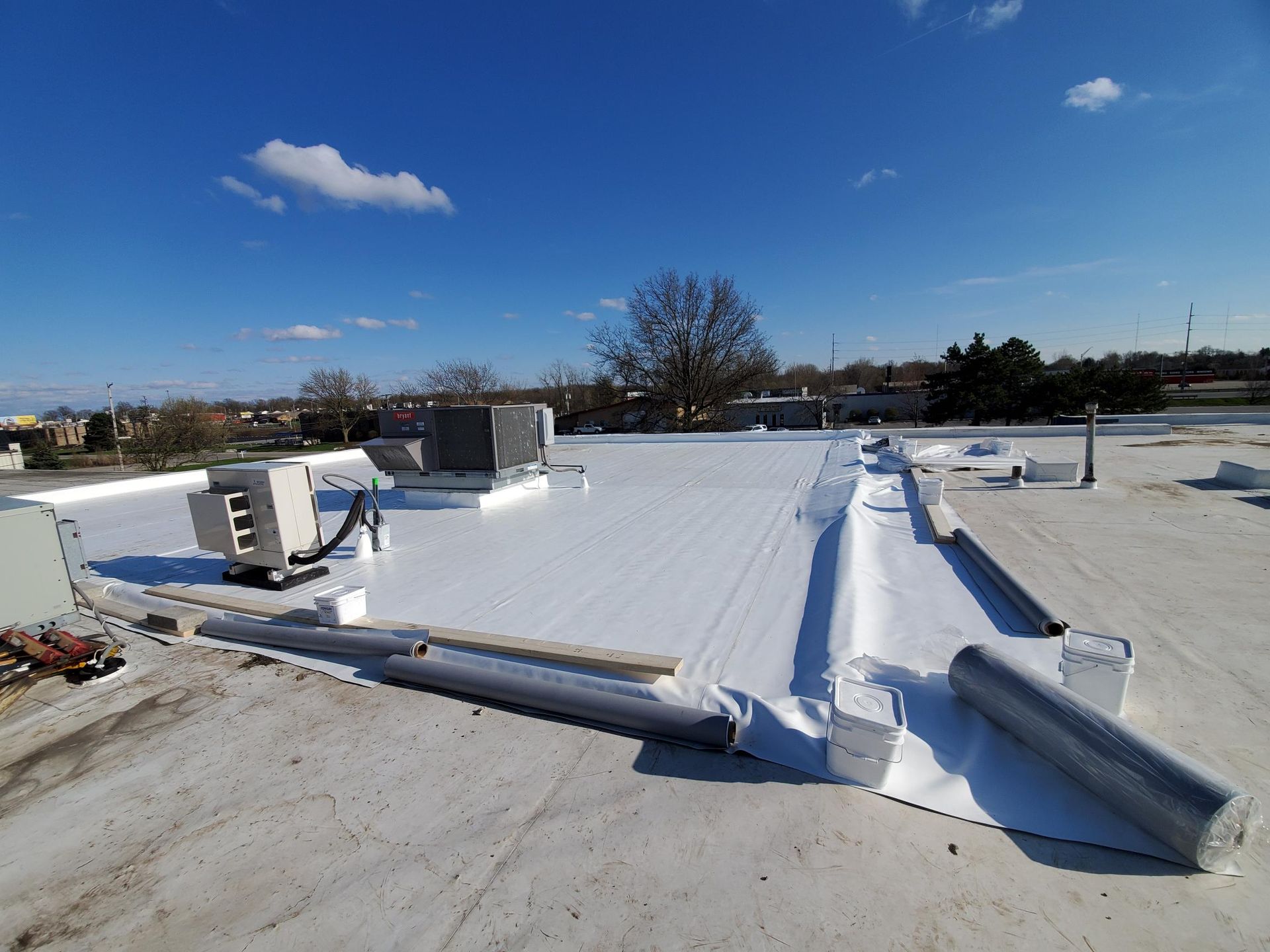 A white roof is being installed on top of a building.