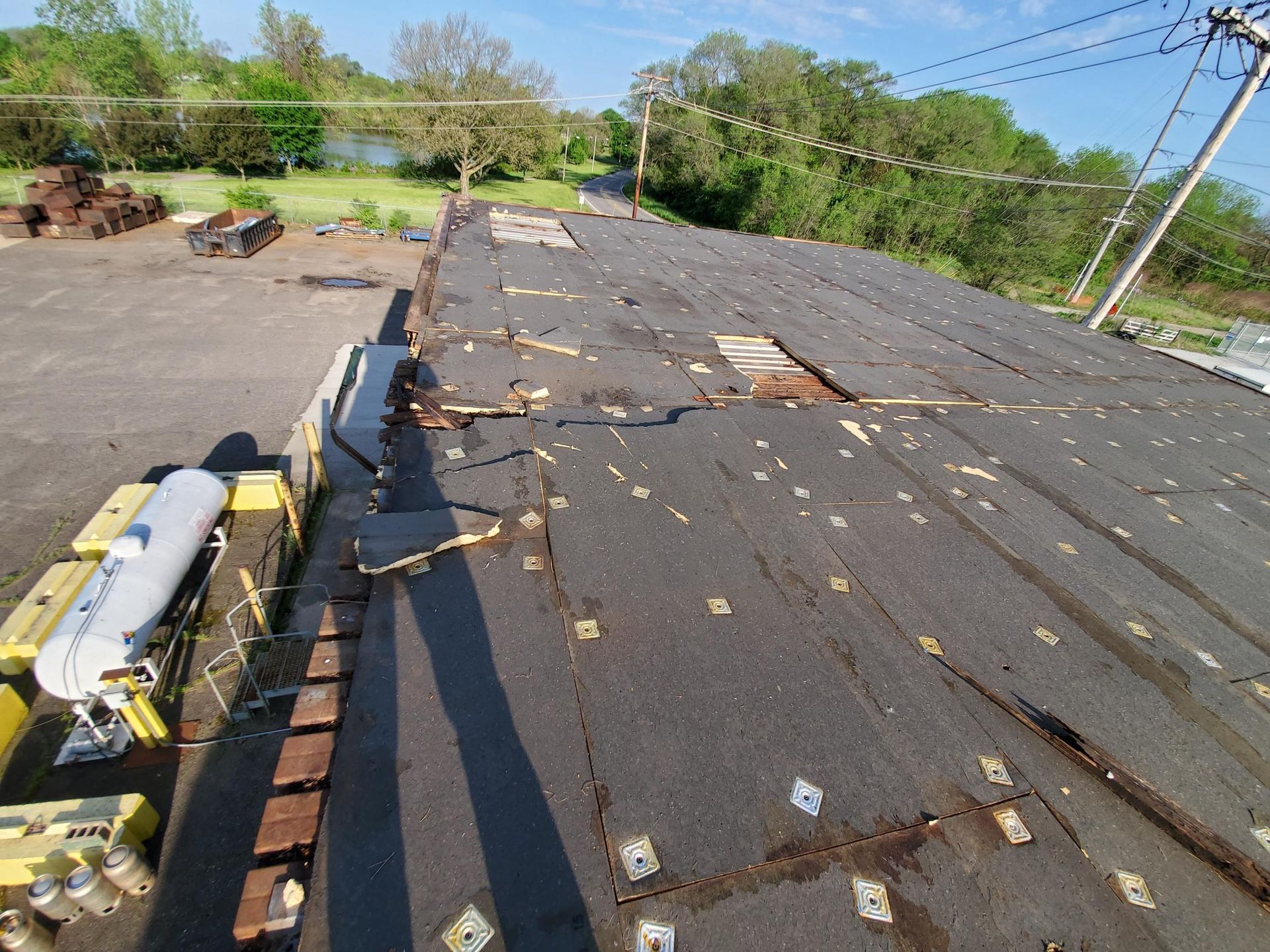 An aerial view of a roof that is being repaired